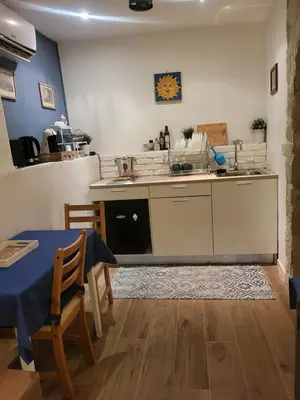a kitchen with a table and a sink and a stove at Il Rifugio in Palermo