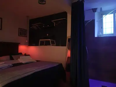 a dark room with a bed and a window at Il Rifugio in Palermo