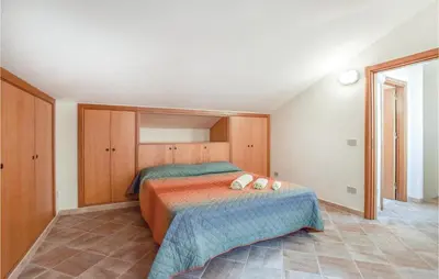 a bedroom with a bed with two pillows on it at Casa Sardina in Mandra Capreria