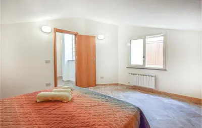 a bedroom with a large bed and a window at Casa Sardina in Mandra Capreria