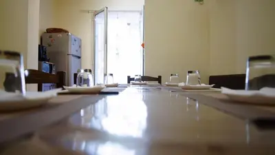 a long table with white plates on top of it at LE PORTE DI PALERMO in Palermo