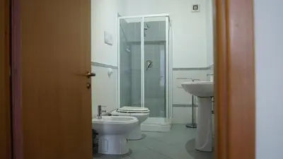 a bathroom with a toilet and a sink at LE PORTE DI PALERMO in Palermo