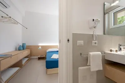 a bathroom with a sink and a mirror at Vitop Residence in San Vito lo Capo