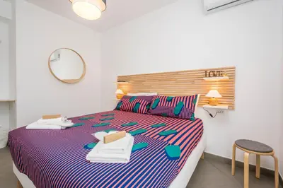 a bedroom with a bed and a mirror and a chair at B&B Lo&G in Lascari