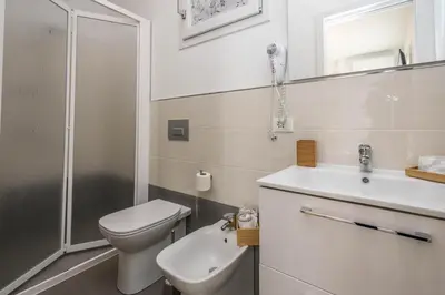 a bathroom with a toilet and a sink and a shower at B&B Lo&G in Lascari