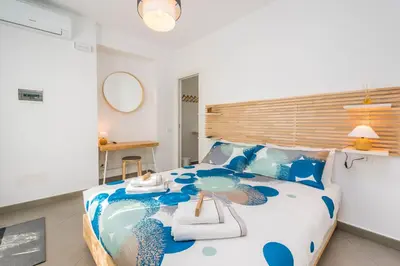 a bedroom with a large blue and white bed at B&B Lo&G in Lascari