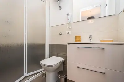 a bathroom with a toilet and a shower at B&B Lo&G in Lascari