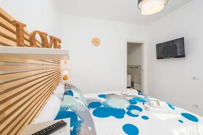 a bedroom with a bed with a computer on it at B&B Lo&G in Lascari