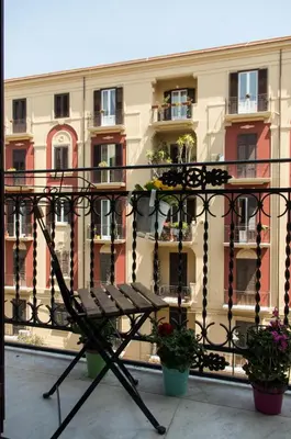 a bench on a balcony in front of a building at Sammartino 108 in Palermo