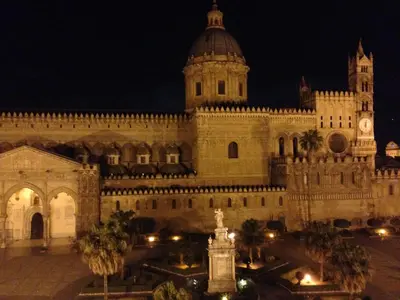 a large building with a clock tower at night at Sammartino 108 in Palermo