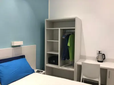 a bedroom with a bed and a desk and a closet at White Asses Rooms in Castellammare del Golfo