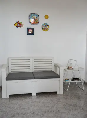 a white bed sitting against a white wall at Casa Pomelia in Castellammare del Golfo