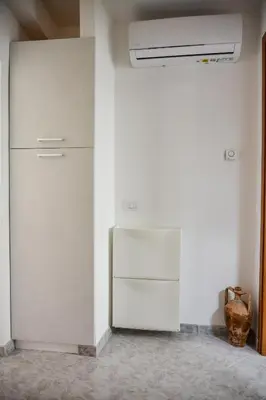 a white refrigerator in a room with a wall at Casa Pomelia in Castellammare del Golfo