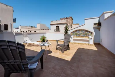 a patio with a table and chairs on a balcony at Azulè in San Vito lo Capo