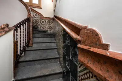 a staircase in a house with rusty iron railings at Azulè in San Vito lo Capo