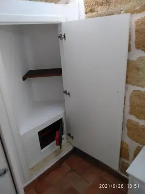 a closet with a white door and a fireplace at La casetta in Terrasini