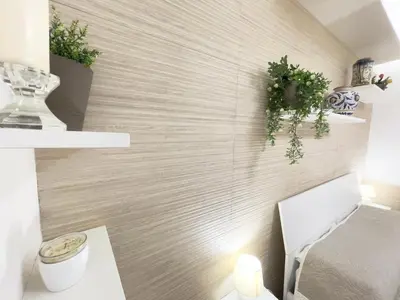 a bathroom with a white toilet and some plants at CATHEDRAL APARTMENT in Palermo