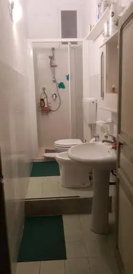 a bathroom with a toilet and a sink and a shower at Casa Rdue a quiet historic center of Palermo in Palermo