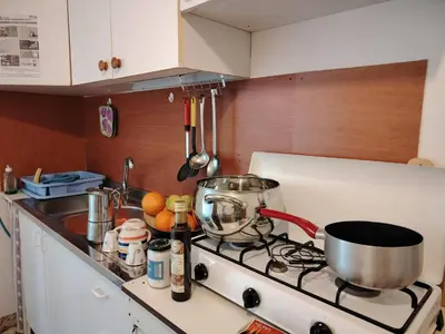 a kitchen with a stove with a pot on it at Le spezie 2PD Climatizzata in Castellammare del Golfo