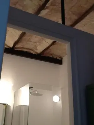 a room with a ceiling and a door with a mirror at Casa Nonnona in Palermo