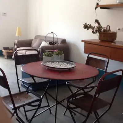 a table and chairs in a living room with a couch at Casa Nonnona in Palermo
