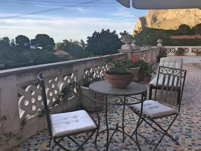 two chairs and a table on a balcony at Casa Nonnona in Palermo