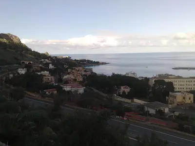 a view of a city and the ocean from a hill at Casa Nonnona in Palermo
