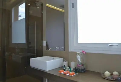 a bathroom with a sink and a large mirror at B&b Mondello Resort in Palermo
