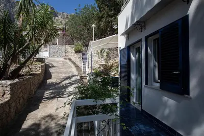 a balcony of a house with a window and a sidewalk at Villa Aurora Mondello Addaura in Mondello