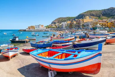 a group of boats sitting on the beach at Sea Room Aspra in Bagheria