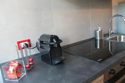 a kitchen counter with a mixer and a sink at Mondello Apartment in Mondello