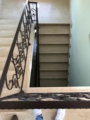 a person standing on a staircase with white shoes at Krimar Hotel in San Vito lo Capo