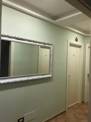a mirror on a wall in a room at Krimar Hotel in San Vito lo Capo