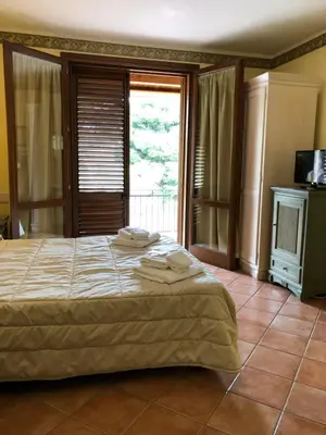 a bedroom with a bed with towels on it at Krimar Hotel in San Vito lo Capo