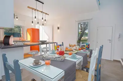 a kitchen and dining room with a table and chairs at Casa del Melograno con idromassaggio e giardino in Terrasini