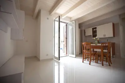 a kitchen and dining room with a table and chairs at Duchessa in Castellammare del Golfo