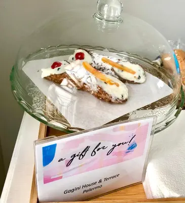 a plate of food in a glass bowl on a table at Gagini House & Terrace in Palermo