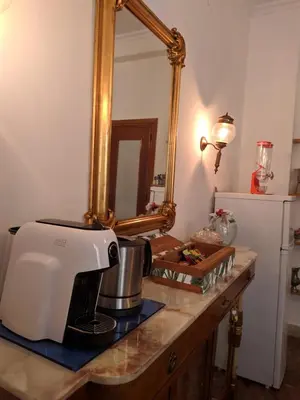 a kitchen counter with a mixer and a mirror at Olivarooms in Palermo