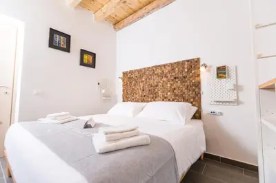 two beds in a white room with towels on the bed at Mosina Apartments in Palermo
