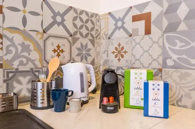 a kitchen counter with a coffee maker and other kitchen items at Mosina Apartments in Palermo