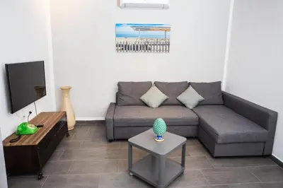 a living room with a couch and a table at Mosina Apartments in Palermo