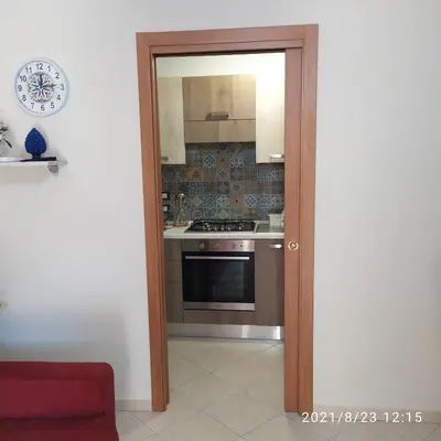 an open door to a kitchen with a stove at STONE HOUSE e Casa Vacanze Zia Rosina in Montemaggiore Belsito