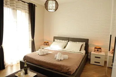 a bedroom with a bed with towels on it at Terra Sinus Holiday House in Terrasini