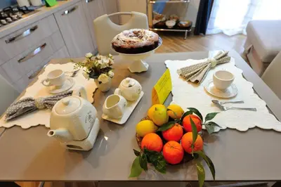 a table with fruits on it in a kitchen at Terra Sinus Holiday House in Terrasini