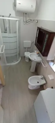 a bathroom with two toilets and a shower and a sink at casa nina in Mondello