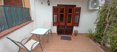 a chair and a table in front of a building at casa nina in Mondello