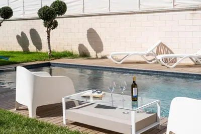 an overhead view of a swimming pool with lounge chairs at Villa Uluvud with Pool Gym Sauna in Alcamo