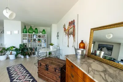 a living room with a mirror and a table at Villa Uluvud with Pool Gym Sauna in Alcamo