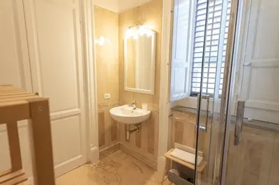 a bathroom with a sink and a glass shower at Liberty Palace in Palermo