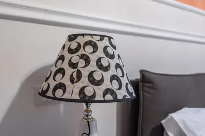 a lamp sitting on a table next to a couch at Liberty Palace in Palermo